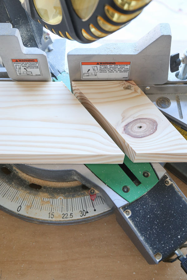 Cut the top point of the DIY wood Christmas tree using a 36 degree angle on miter saw