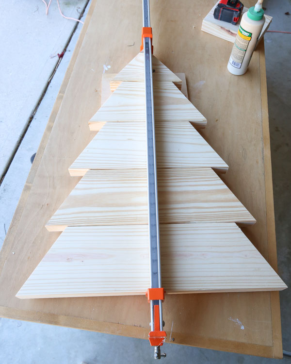using 48 inch clamp to clamp together boards for largest DIY wooden Christmas tree