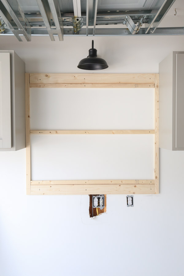 installing the pegboard back frame on the wall with 1x2 furring strips support boards