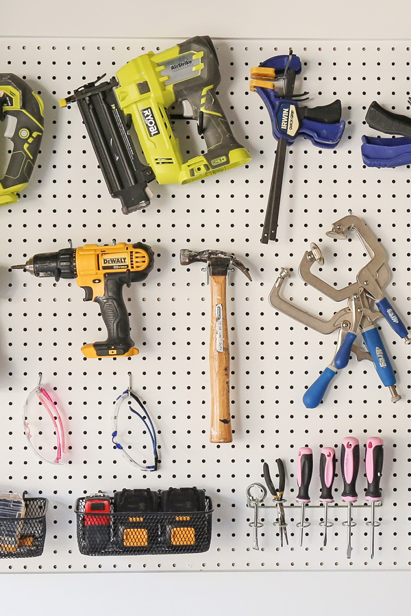 peg hooks and peg holders with tools on pegboard wall