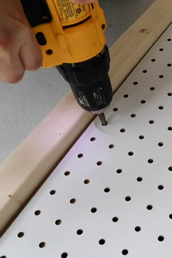 Install the pegboard to the pegboard stand DIY with screws and drill
