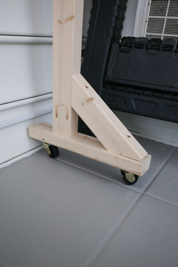 attach the casters to the mobile DIY pegboard stand