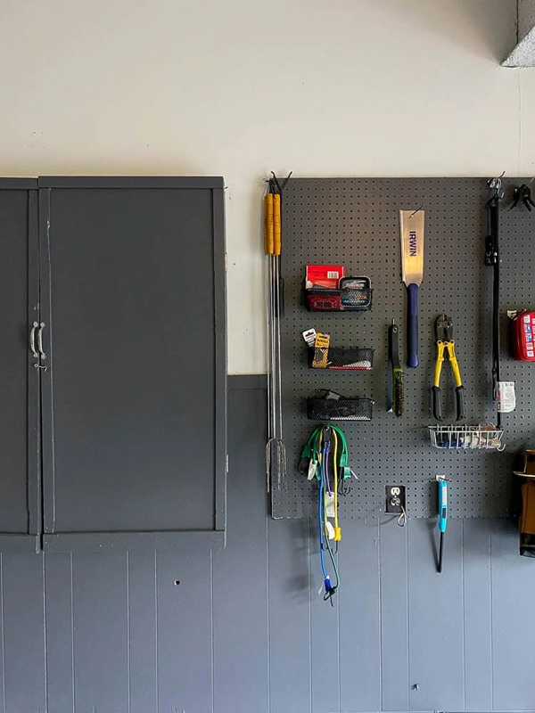 Garage by Bigger Than the Three of Us with black and white painted garage wall