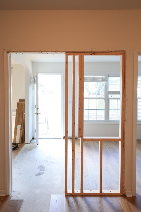 small partition wall framed out with interior window and flooring removed