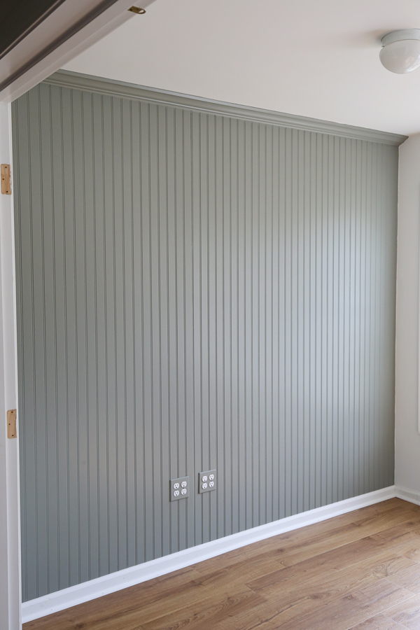 gray green DIY beadboard wall with wood floors in office