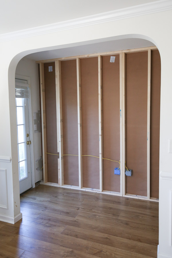 wall before installing vertical shiplap with wall studs exposed