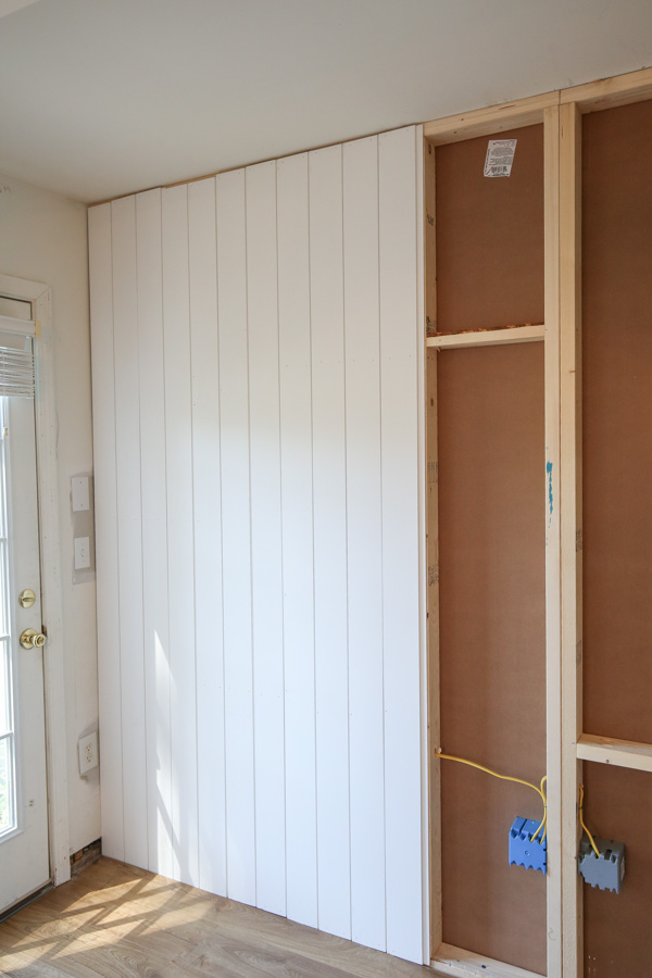 diy vertical shiplap wall in process with floor to ceiling shiplap