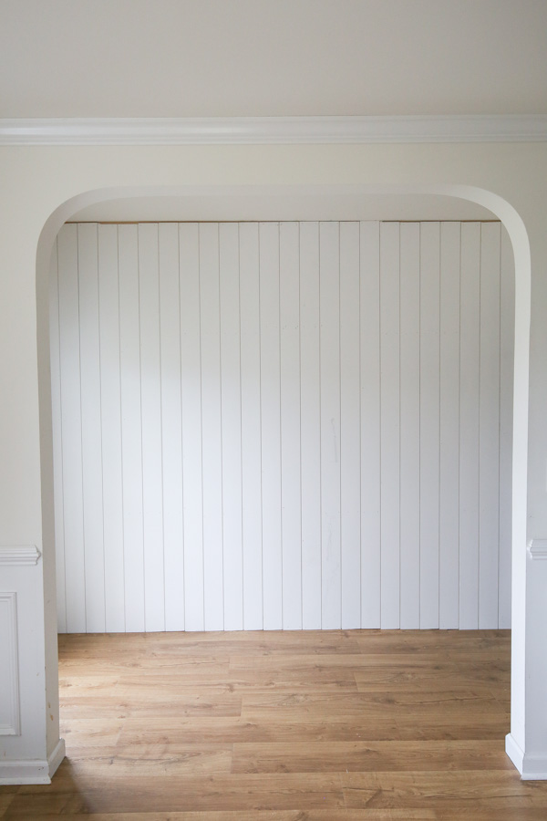 vertical shiplap wall installed with real shiplap before adding crown molding and baseboard