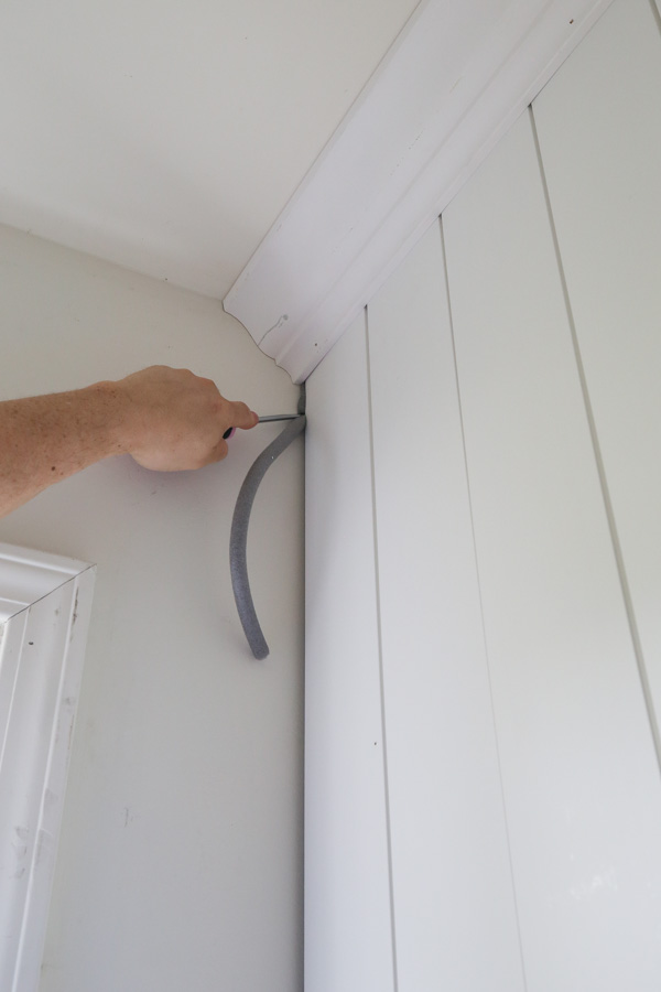 installing backer rod for gap between the first shiplap board and wall for easy caulking