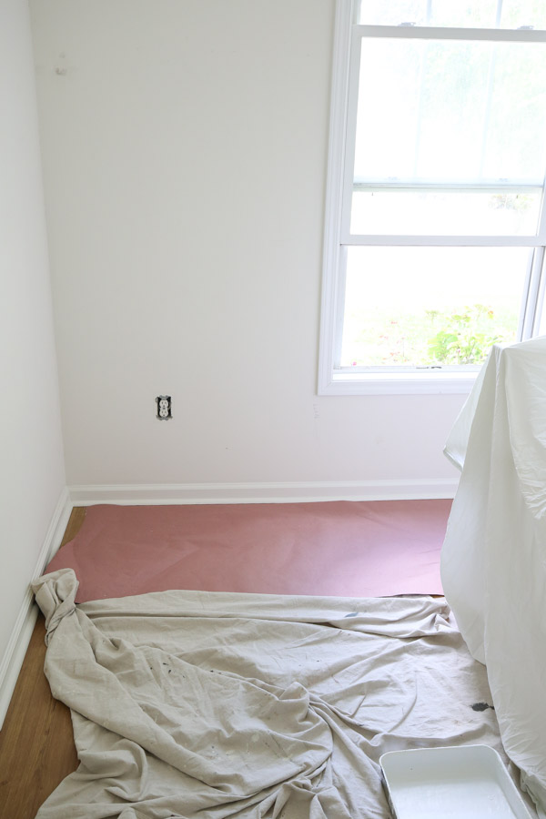prep floor for paint with flooring paper and drop cloth