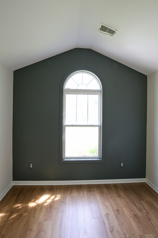 DIY painted accent wall with vaulted ceilings and arch window