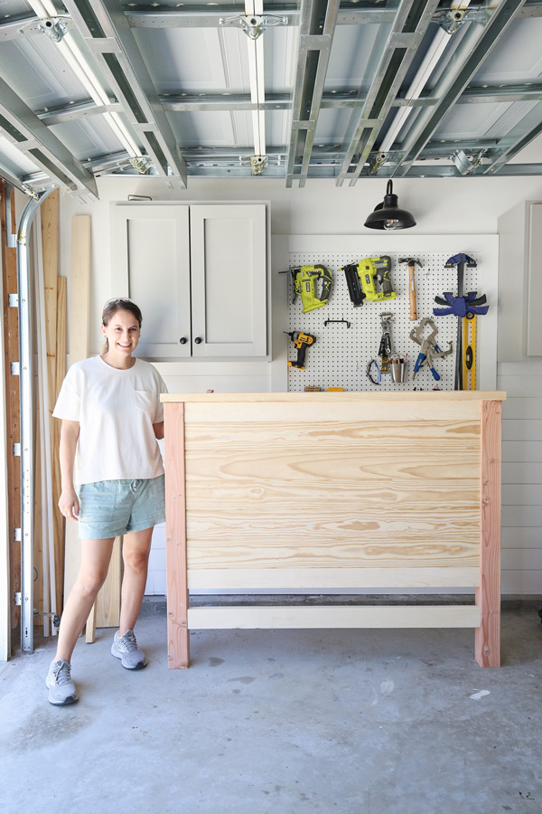 woman DIYer and shiplap headboard DIY