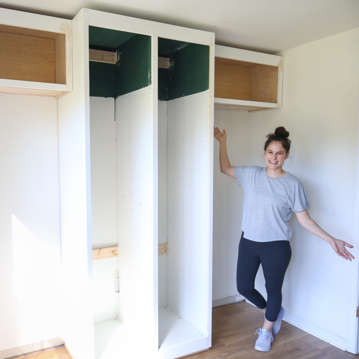 woman DIYer in front of diy built in office cabinets