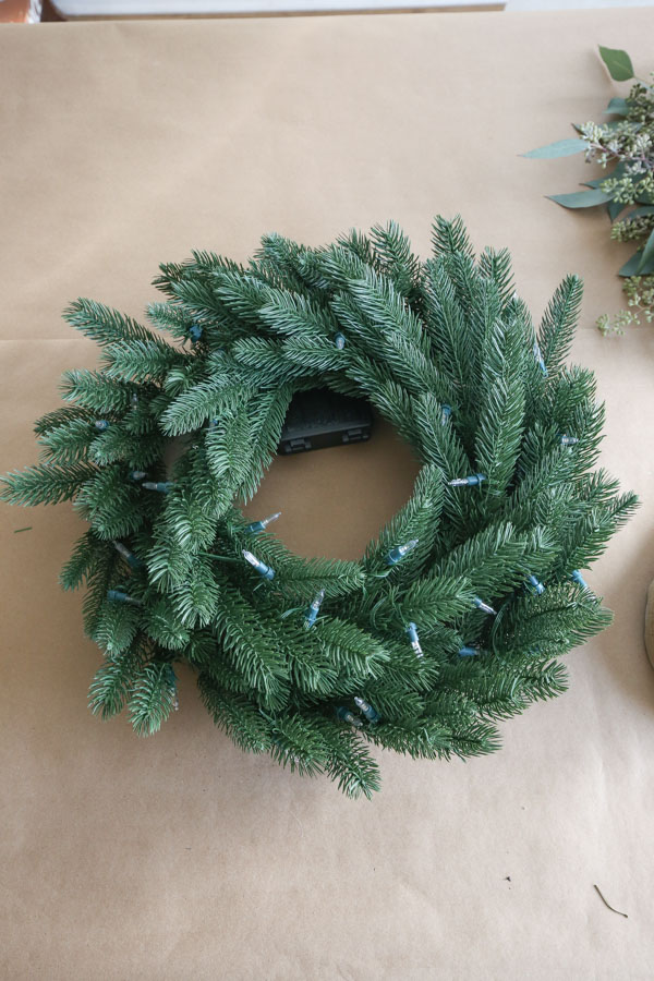 faux Christmas wreath that looks real and pre-lit with lights
