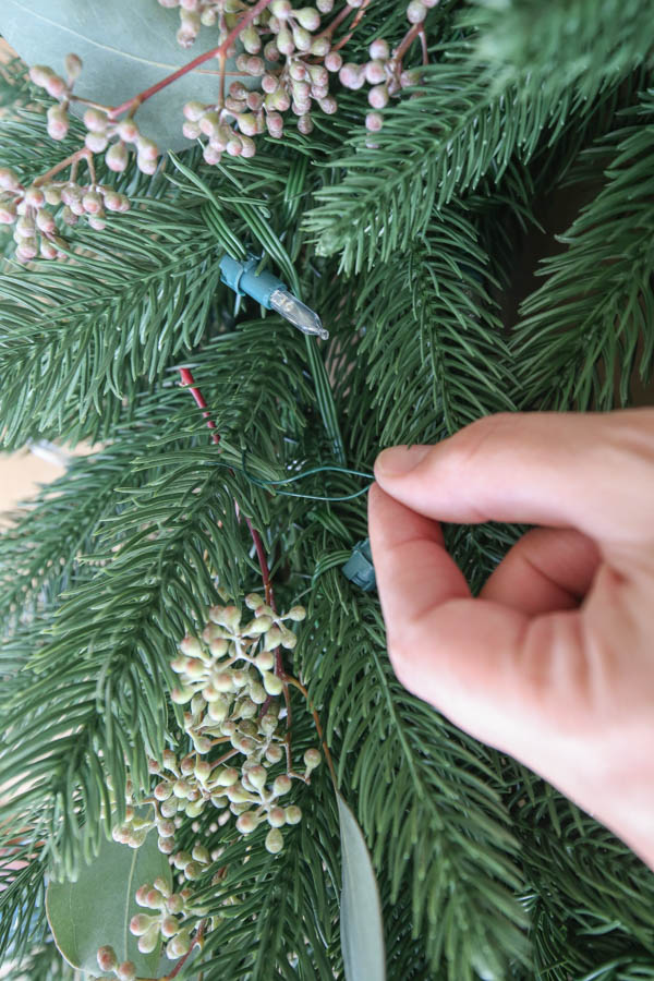 attaching real greenery to faux wreath with floral wire