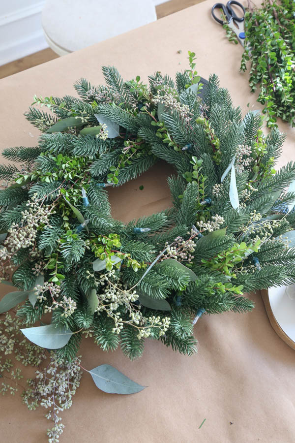 adding boxwood to DIY minimalist Christmas wreath