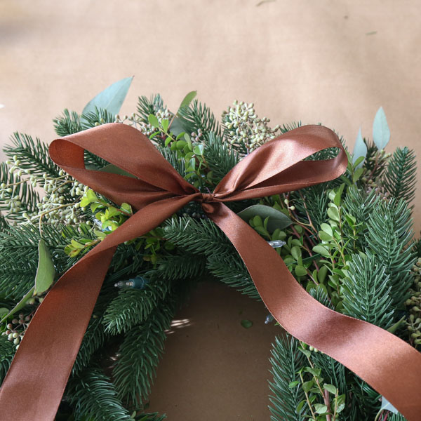 perfect bow with brown satin ribbon on to DIY minimalist Christmas wreath