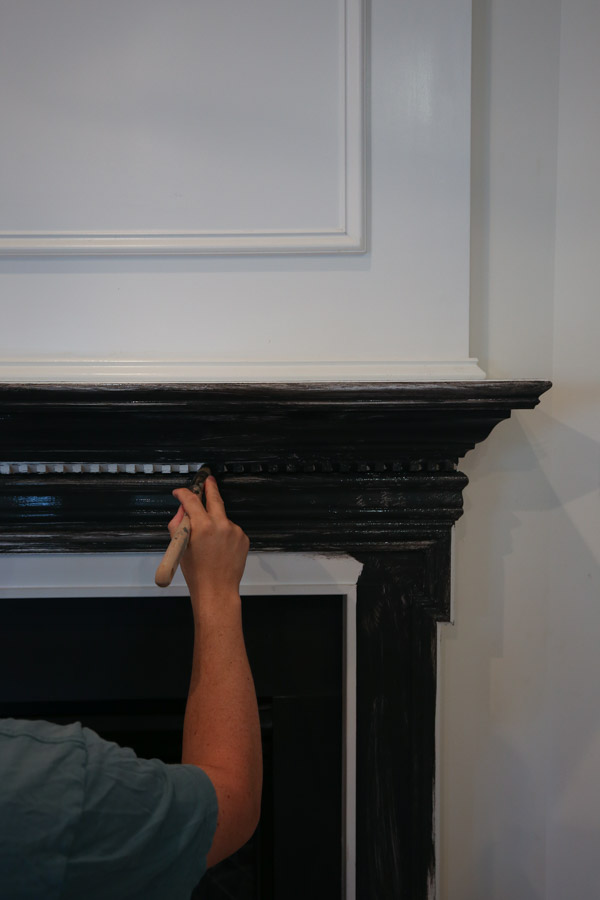 painting a fireplace with black paint