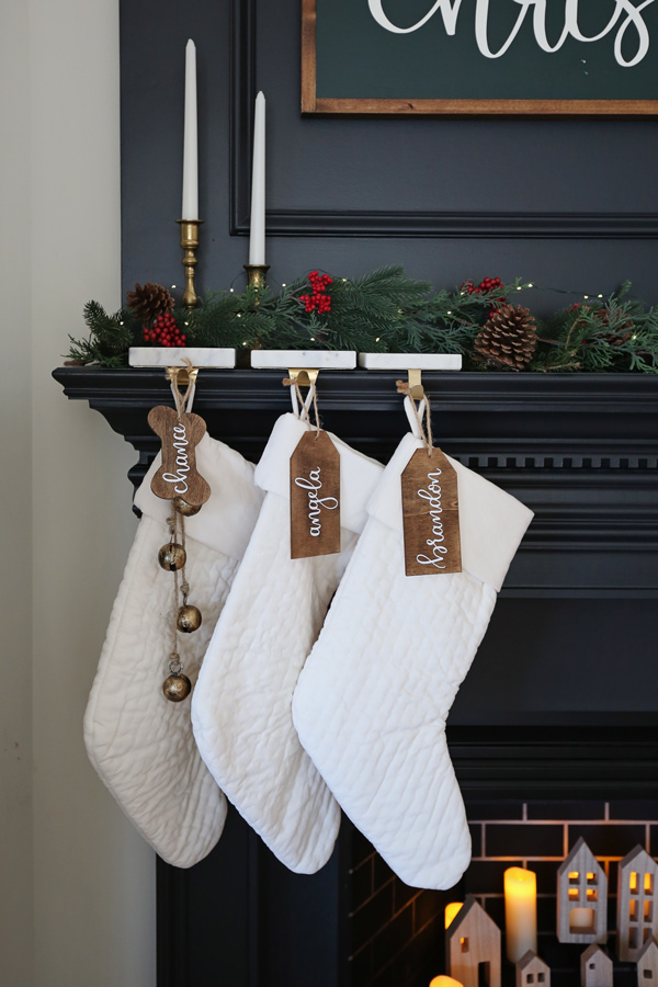 minimalist christmas mantel with stockings and bells