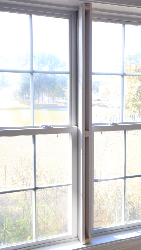 installing DIY window trim between two windows
