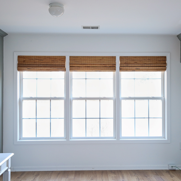 window makeover with DIY window trim between windows and budget friendly bamboo blinds from amazon