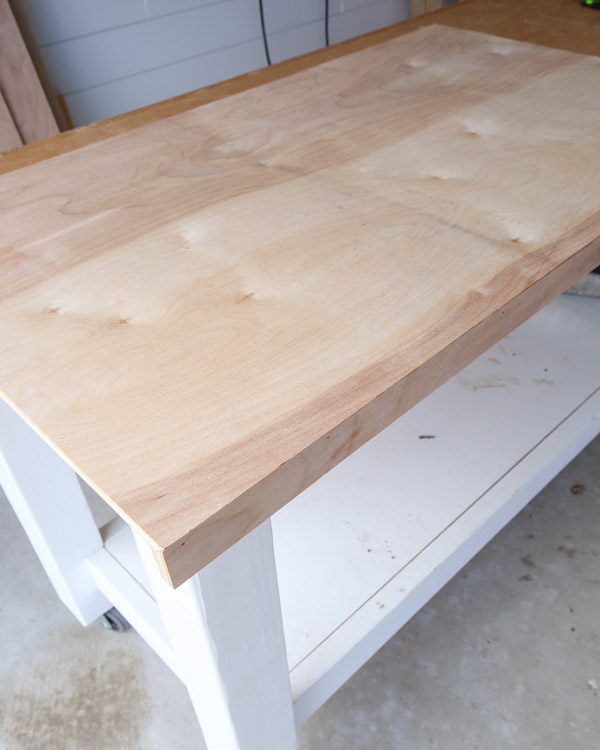 DIy wood desk top made with birch plywood that is sanded but not stained yet
