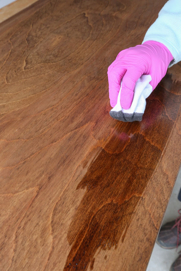 how to stain birch plywood - applying second coat of wood stain with lint free rag into grain of wood