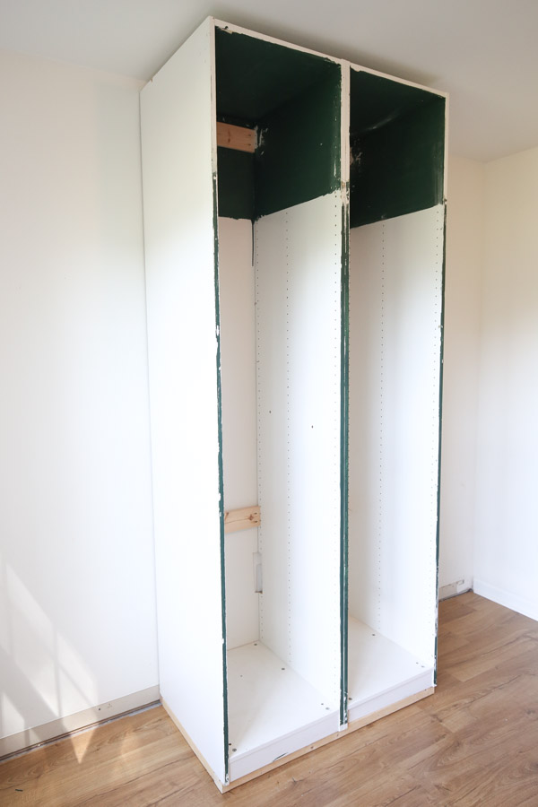 ikea pax cabinets attached to wall and sitting on base support