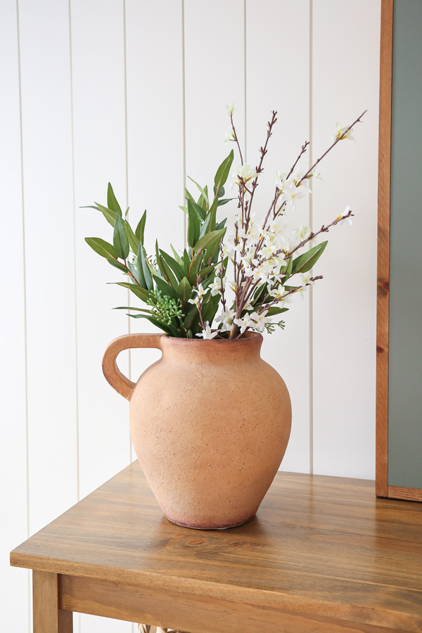 terracotta vase with spring branches on table for spring decor from target