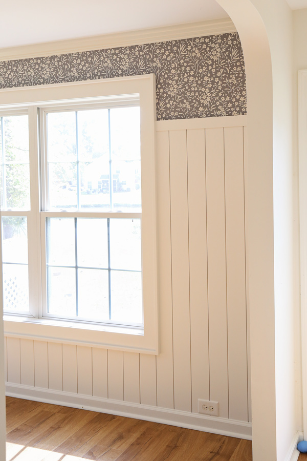 DIY peel and stick wallpaper around window and above shiplap in dining room