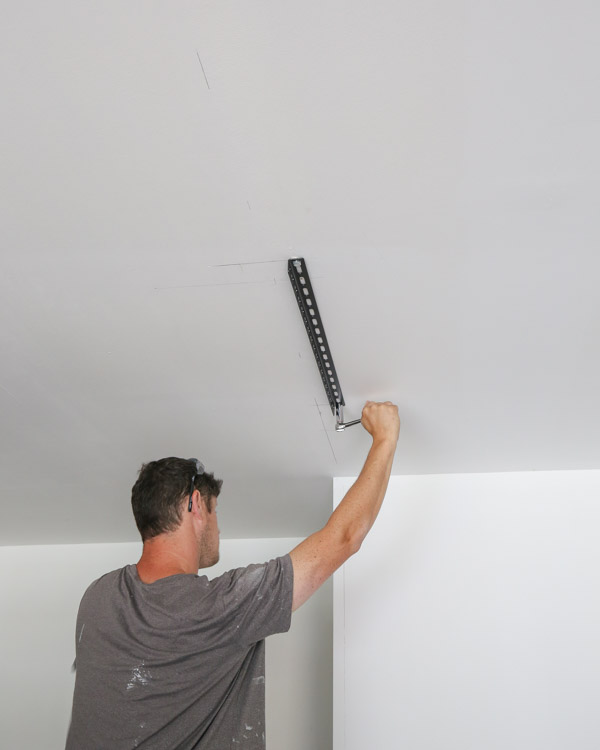 Installing the ceiling brackets into the ceiling joists with a handle ratchet
