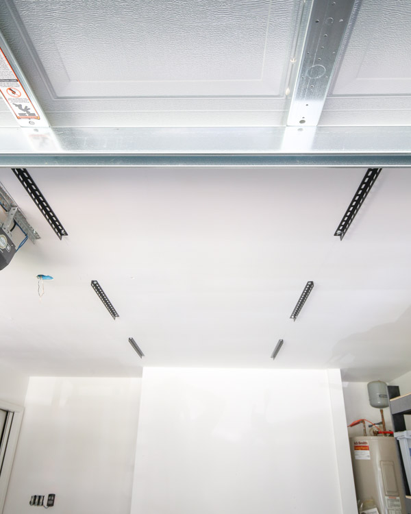 brackets installed into ceiling joists for garage storage ceiling diy