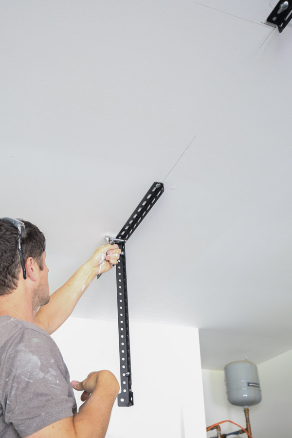 installing vertical supports for DIY Garage Ceiling Storage shelves
