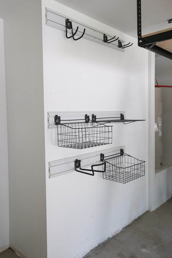 gladiator geartrack wall tracks on garage wall for wall organization with baskets, hooks, and shelf