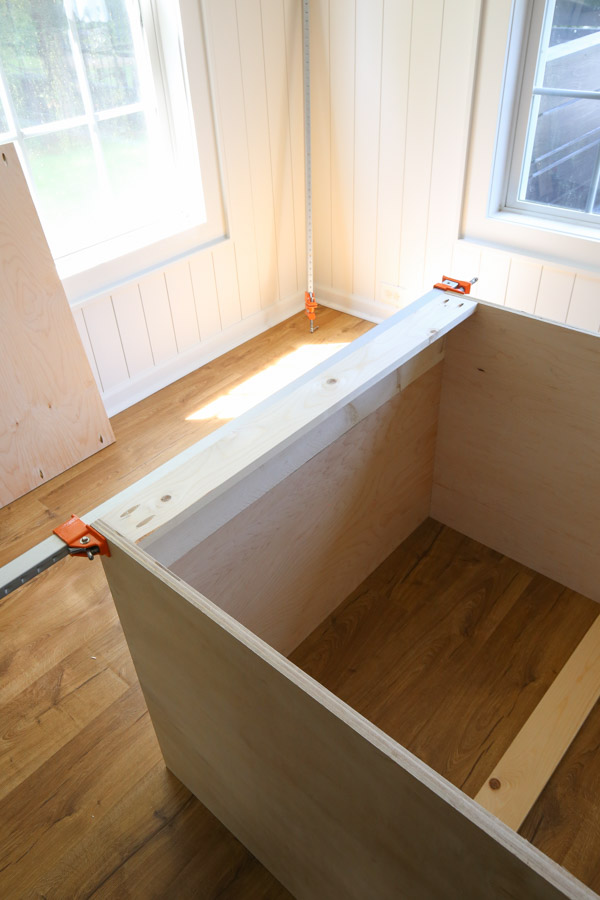 assembling top frame of refrigerator cabinet with long clamps