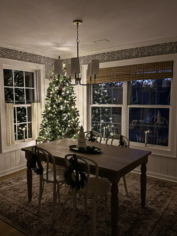 candle Christmas window in dining room window at night with charming vintage candle holder and flameless candles