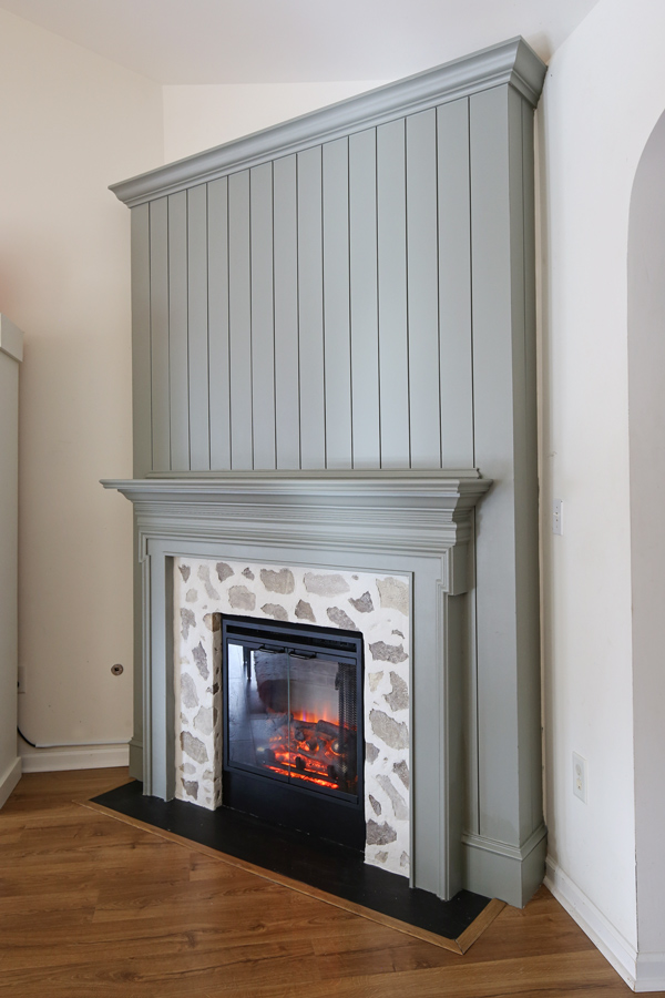 gray green DIY shiplap fireplace with a faux stone fireplace DIY surround