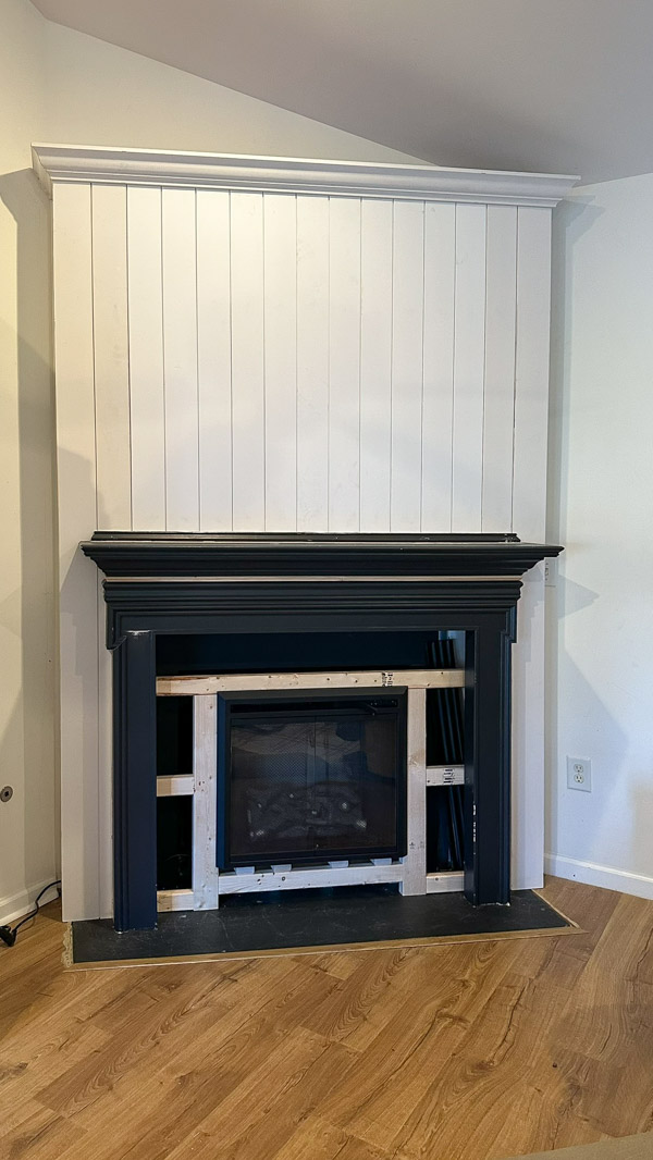 installing mantel on DIY shiplap fireplace wall