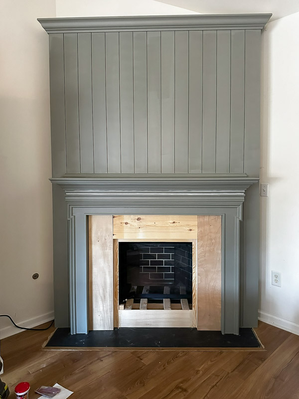 DIY shiplap fireplace wall before electric insert and surround