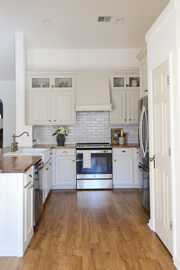 kitchen makeover with diy range hood cover and glass cabinets
