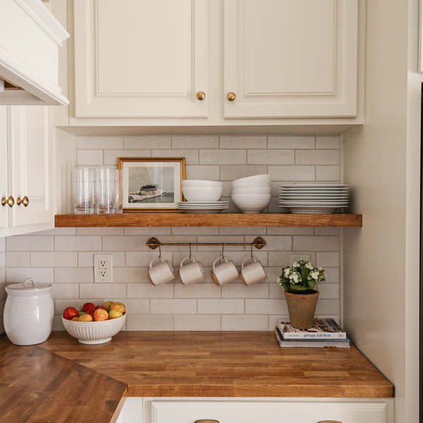 kitchen makeover with diy kitchen floating shelf and brass kitchen rail with mugs