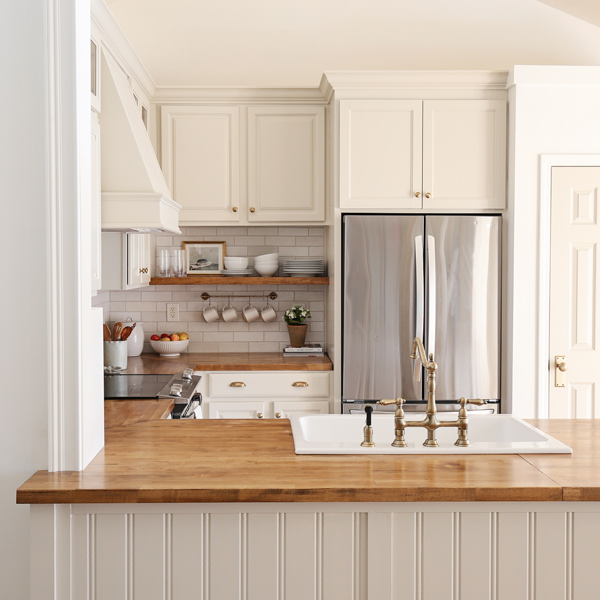 diy kitchen makeover with butcher block countertops and DIY kitchen island with beadboard, and built in refrigerator cabinet