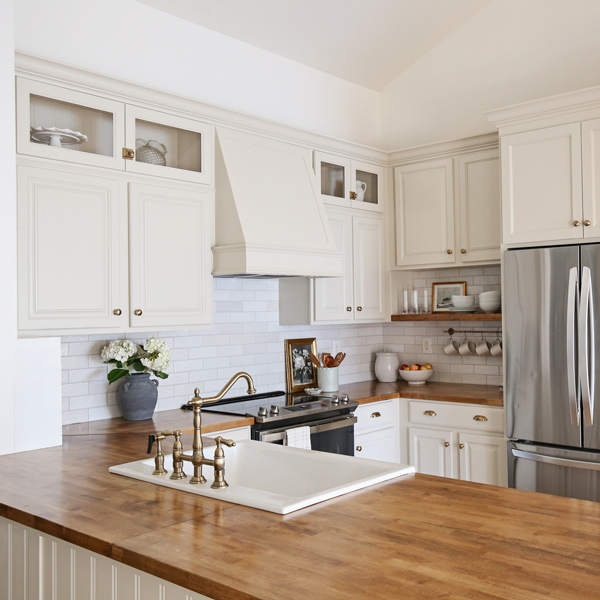 diy kitchen makeover with butcher block countertops and diy range hood cover and floating shelf