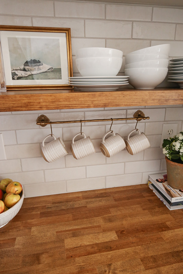 kitchen makeover with diy kitchen floating shelf and brass kitchen rail with mugs