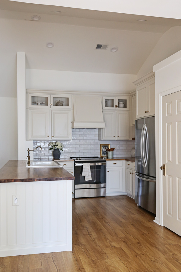 kitchen makeover with diy range hood cover and glass cabinets