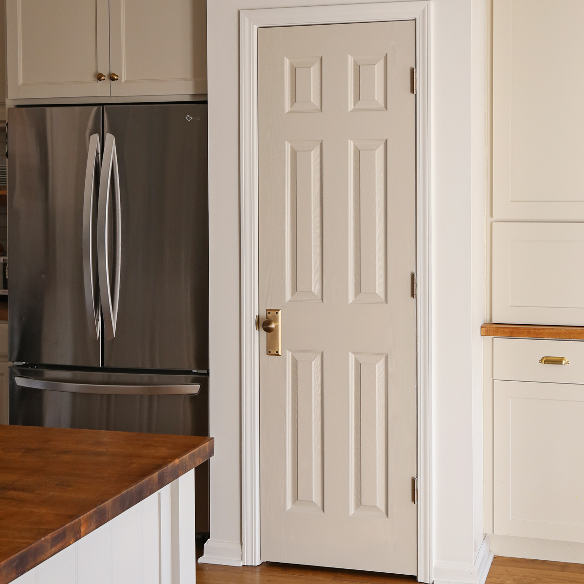 vintage antique brass door knob on gray painted pantry door in kitchen for pantry door makeover refresh