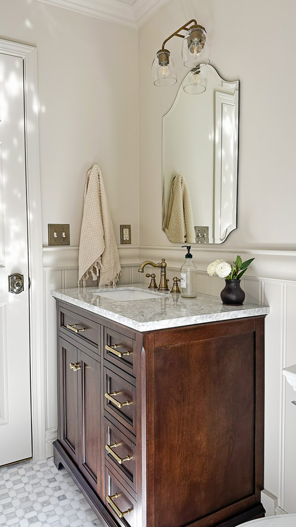 vintage charm bathroom makeover with beadboard wainscoting, chair rail, marble floors and wood vanity