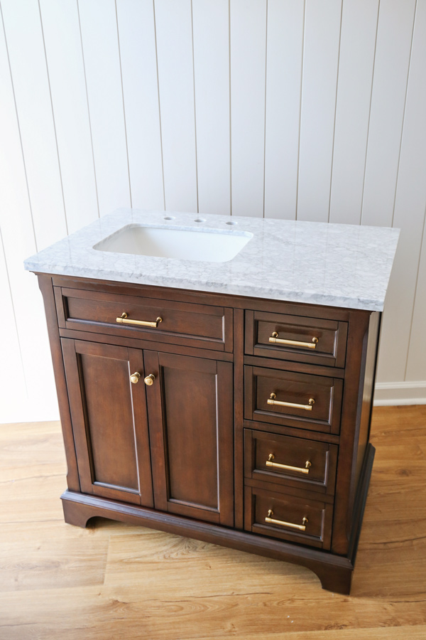 Lowe's wood bath vanity with marble sink top before install