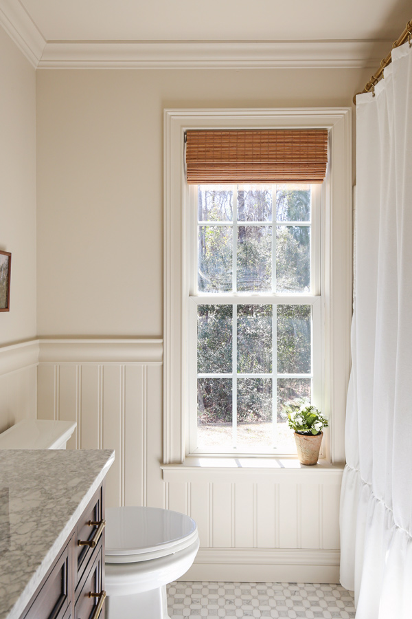 vintage charming bathroom makeover with beadboard wainscoting, chair rail and bamboo shades on window