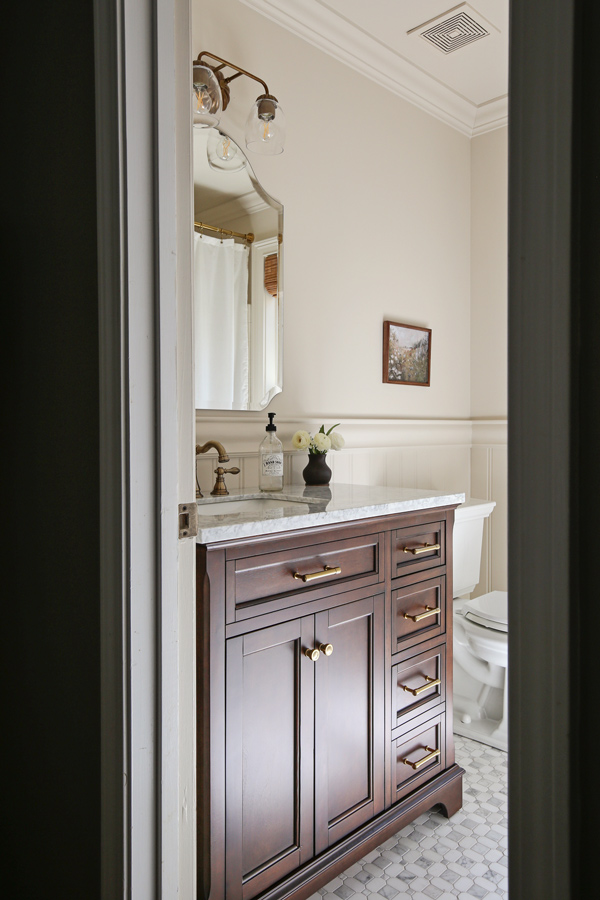 bathroom makeover with beadboard wainscoting, chair rail, marble floors and wood vanity